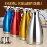 Colorful stainless steel thermal insulation kettles lined up on a wooden surface.